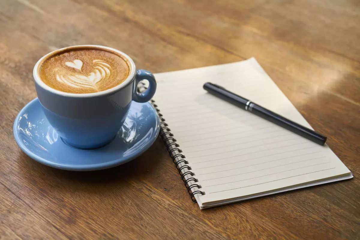 Writing notes and drinking coffee